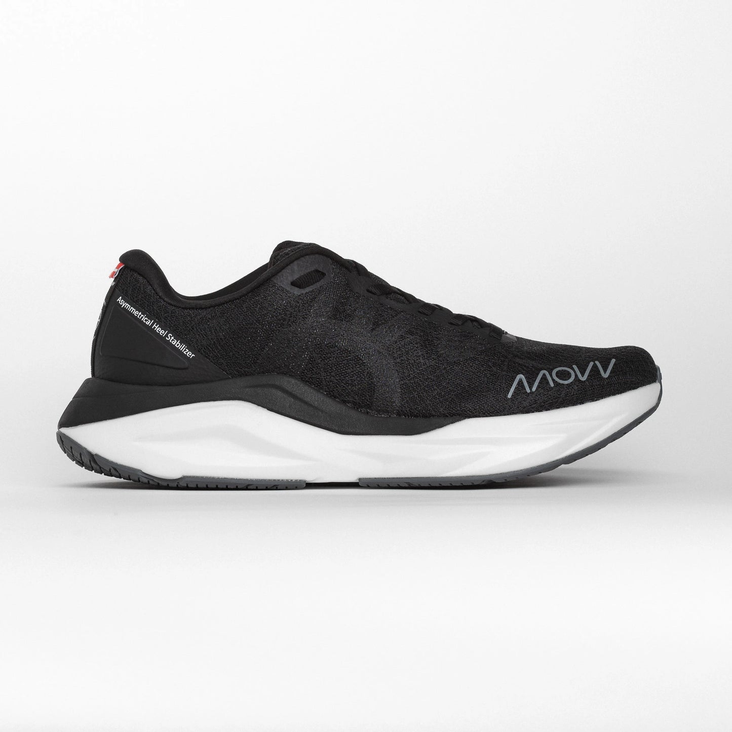 Side profile of a black MOVV running shoe with a white midsole and grey outsole, featuring the brand logo near the toe and an asymmetric heel stabilizer for support.