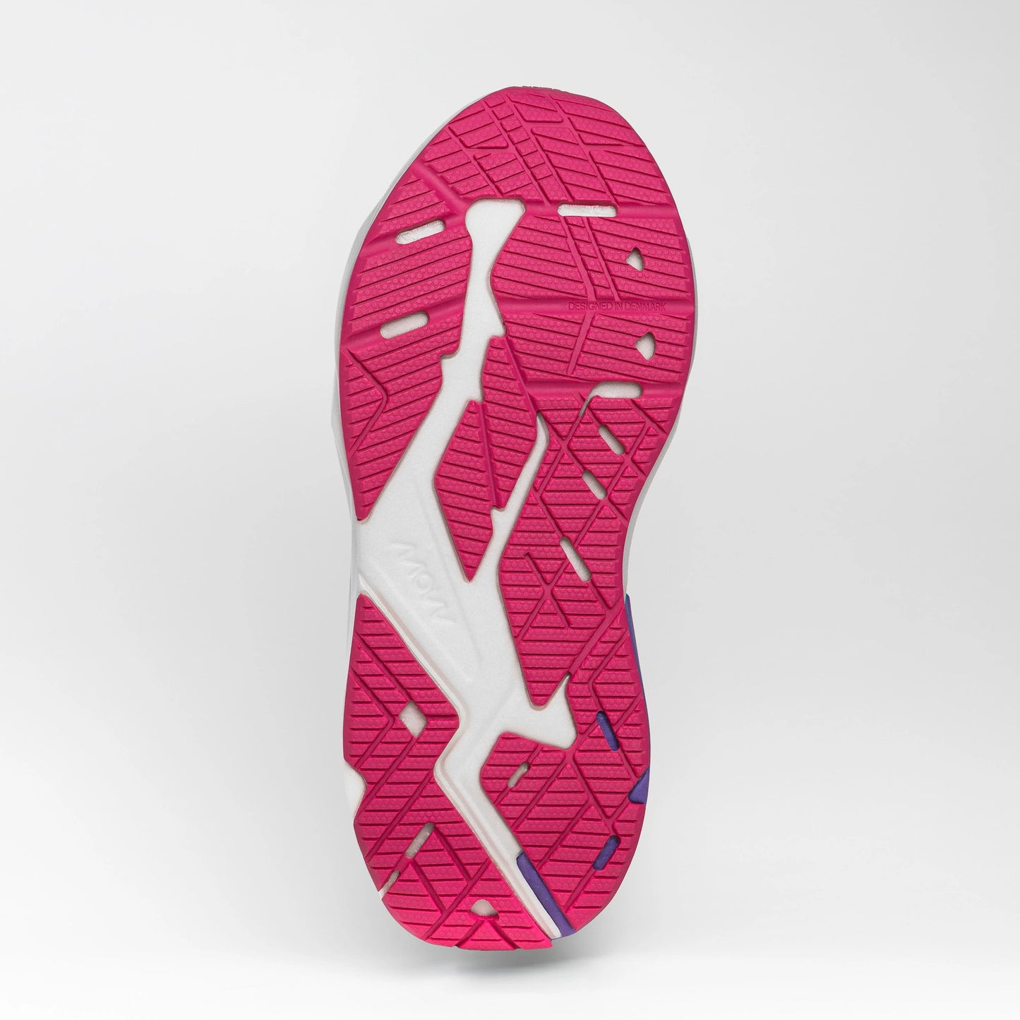 Close-up view of the pink and white rubber outsole of a running shoe, showing its textured tread pattern for grip and flexibility.