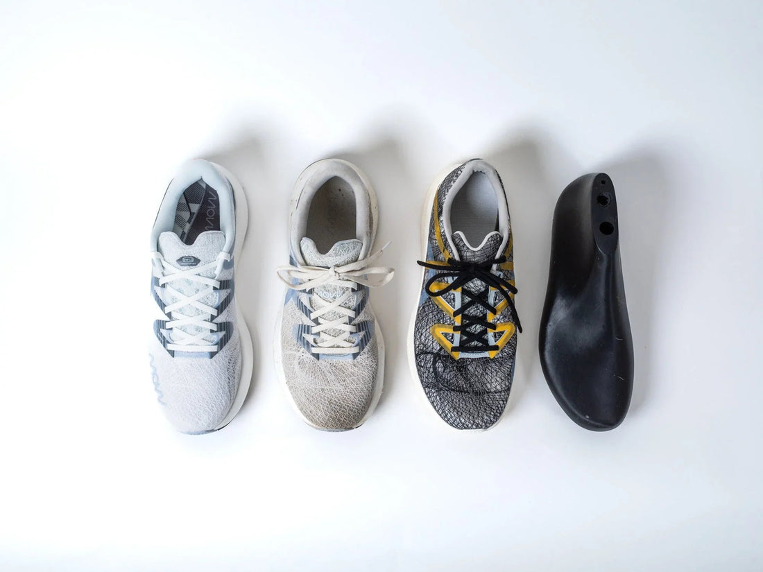 Minimalistic white and grey running shoe designed for injury reduction on white background