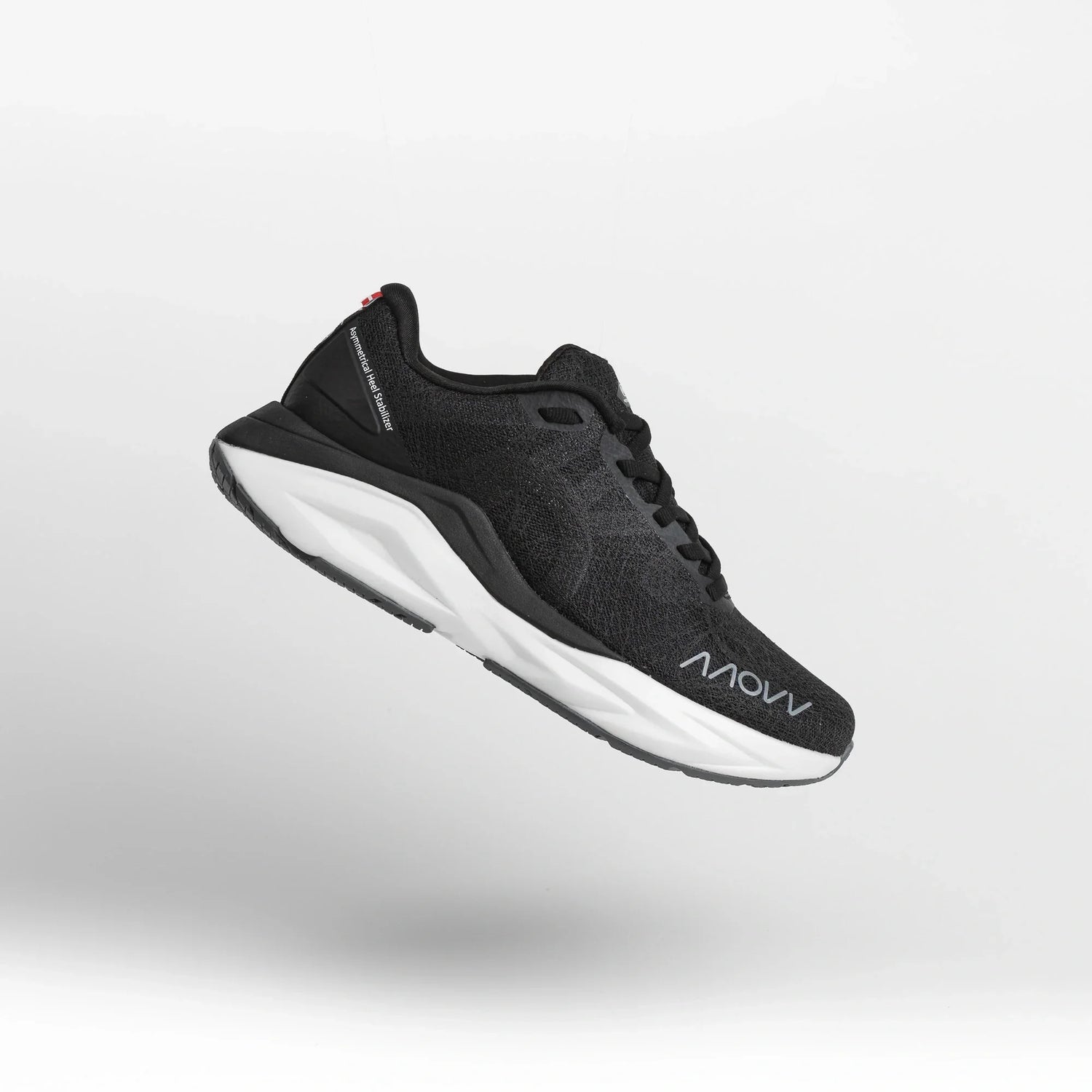 A black athletic running shoe with white midsole photographed against a light gray background. The shoe features a dark mesh upper material, black laces, and MOVV branding visible on the side.