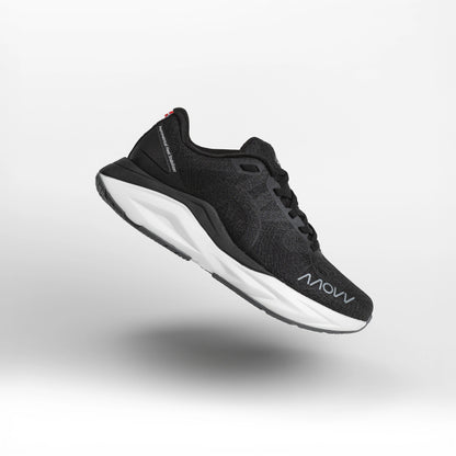 A black athletic running shoe with white midsole photographed against a light gray background. The shoe features a dark mesh upper material, black laces, and MOVV branding visible on the side.