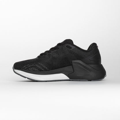 Inner side view of a black MOVV running shoe with a streamlined design, cushioned white midsole, and reinforced black heel structure for stability.