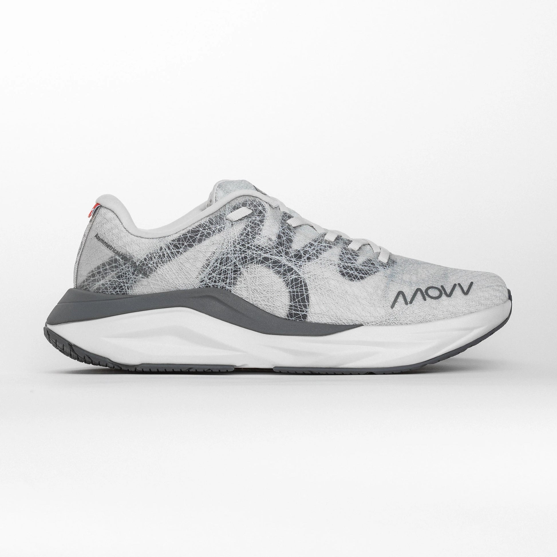 Side profile of a white and grey MOVV running shoe with a grey midsole and grey outsole, featuring the brand logo near the toe and an asymmetric heel stabilizer for support.