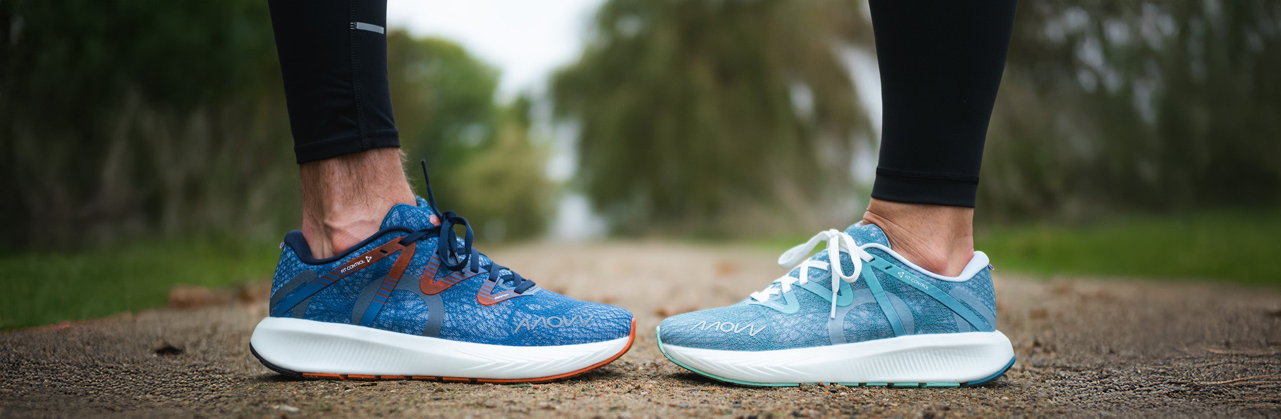 Blue running shoes on a person's feet with a blurred natural background
